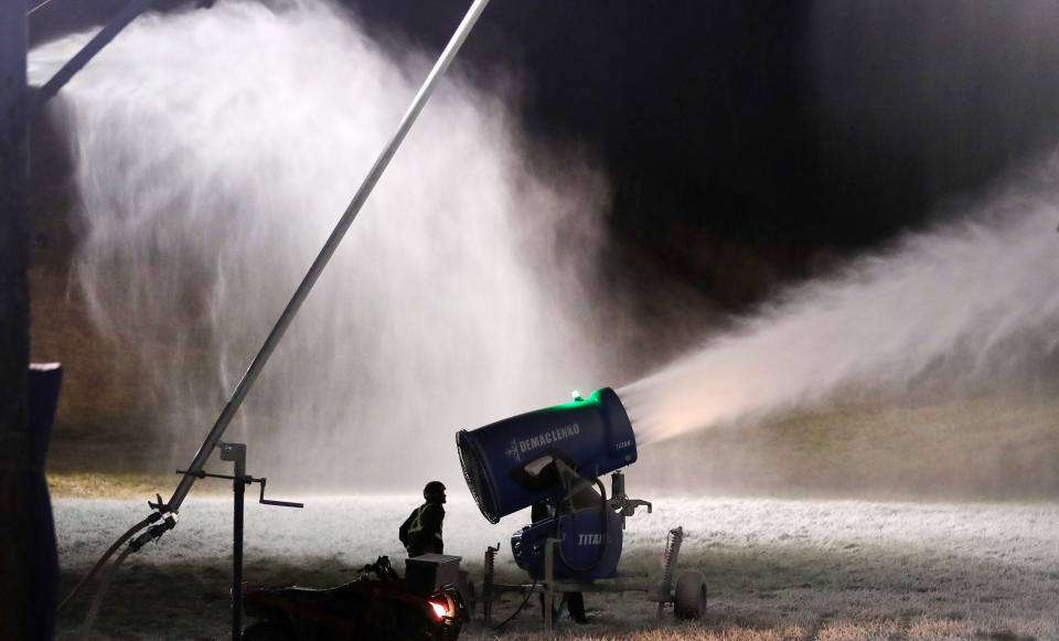 A member of the late night snow making crew at Thunder Ridge Ski Area adjusts one of the snow guns on the mountain in Patterson Nov. 28, 2023.