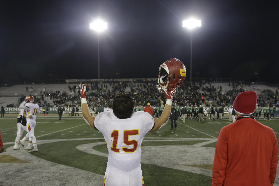 FILE - In this Friday, Dec. 16, 2016, file photo, Cathedral Catholic running back Shawn Poma celebrates after the Dons beat the St. Mary's Rams 38-35, in overtime of the Division 1AA high school football championship game in Sacramento, Calif. The California Interscholastic Federation, California's governing body for high school sports, said Monday, July 20, 2020 that the 2020-21 sports seasons will begin no earlier than December due to the coronavirus pandemic. The CIF said the normal fall, winter and spring sports seasons will be condensed into two seasons. (AP Photo/Rich Pedroncelli, File)