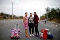 The Wider Image: Venezuelan mothers, children in tow, rush to migrate