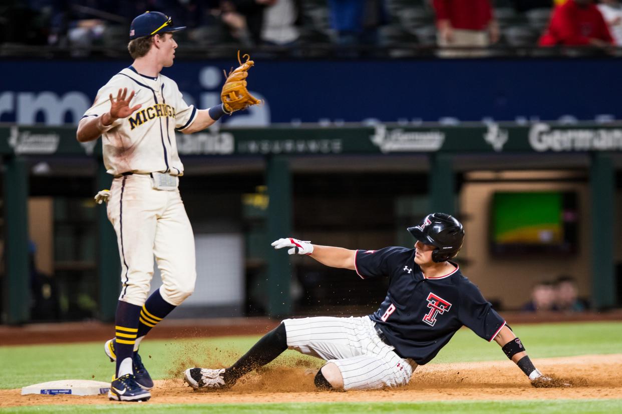 Texas Tech infielder Kurt Wilson (8) slides into third base against Michigan on Feb. 18, 2022 at Globe Life Field in Arlington. On Friday, Wilson successfully stole home in extra innings to beat Texas.