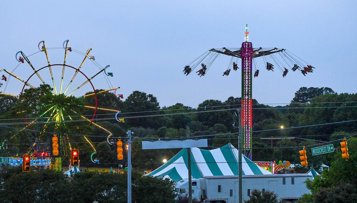 People ride the Zoogogel swing ride as the sun sets during opening day of The Great Anderson County Fair at the Anderson Sports and Entertainment Center in Anderson Thursday, May 4, 2023. The fair lasts 11 days, through May 14, with rides, shows, exhibits, and food. 