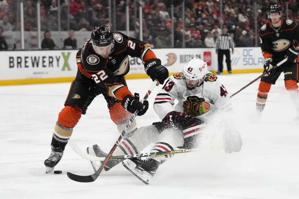 Chicago Blackhawks' Colin Blackwell (43) falls to the ice as he vies for the puck with Anaheim Ducks' Kevin Shattenkirk (22) during the second period of an NHL hockey game Monday, Feb. 27, 2023, in Anaheim, Calif. (AP Photo/Jae C. Hong)