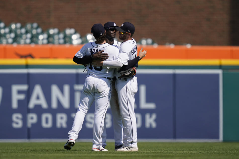 From left, Detroit Tigers left fielder Eric Haase (13), center fielder Daz Cameron (41) and right fielder Robbie Grossman (8) celebrate the Tigers' 8-3 win over the Seattle Mariners in a baseball game, Thursday, June 10, 2021, in Detroit. (AP Photo/Carlos Osorio)