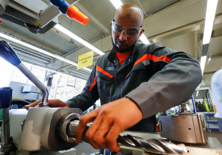 FILE PHOTO: Tarig Mohamed-Idriss, a 26-year-old refugee from Eritrea, exchanges a driller in a miller at the training workshop of Ford Motor Co in Cologne, Germany, November 3, 2016. REUTERS/Wolfgang Rattay/File Photo