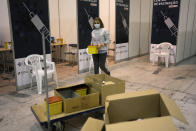 Workers get ready for the opening of a new vaccination center in Lisbon, Tuesday, Nov. 30, 2021. The new center, the biggest in the country, will open Wednesday, Dec. 1. Portuguese health authorities on Monday identified 13 cases of the omicron coronavirus variant among members of a top soccer club and were investigating whether it was one of the first reported cases of local transmission of the virus outside of southern Africa. (AP Photo/Armando Franca)