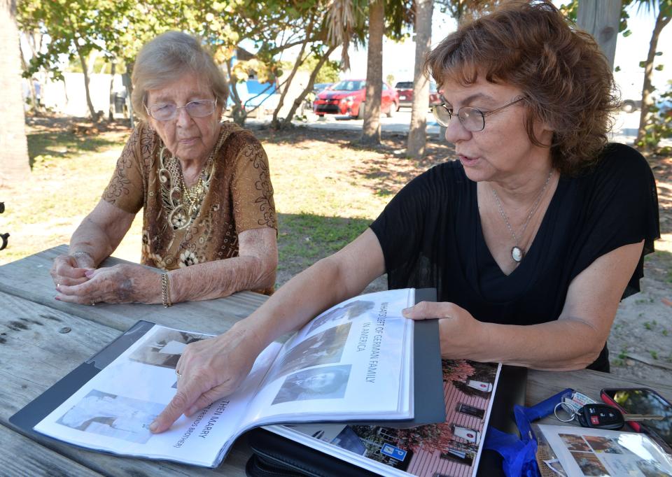 Helga Melmed, 95, a survivor of  Auschwitz looks through photographs from her life, with her daughter, Lisa Bean.  Melmed will share her story in a program hosted by Chabad of Venice. 