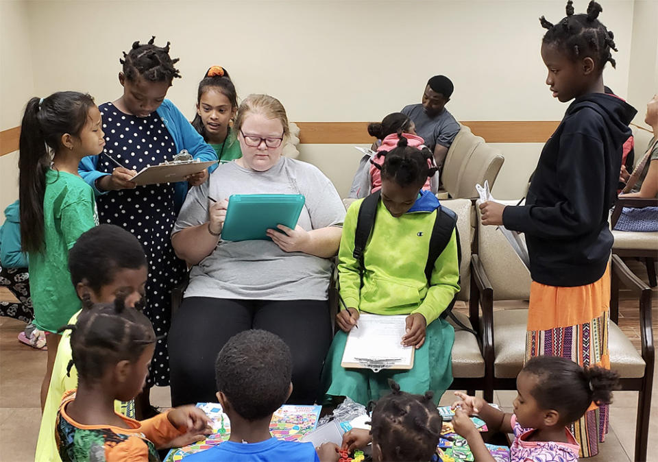 Allie Reeser filled out medical paperwork for children at a health screening. (Star-C)