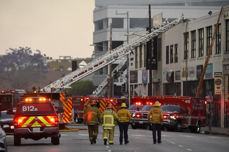 Los Angeles Fire Department firefighters work the scene of a structure fire that injured multiple firefighters, according to a fire department spokesman, Saturday, May 16, 2020, in Los Angeles. (AP Photo/Mark J. Terrill)