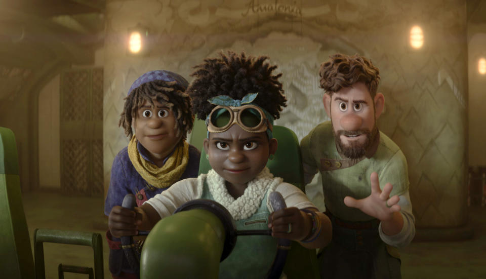 This image released by Disney shows Ethan Clade, voiced by Jaboukie Young-White, left, Meridian Clade, voiced by Gabrielle Union, center, and Searcher Clade, voiced by Jake Gyllenhaal, in a scene from the animated film "Strange World." (Disney via AP)