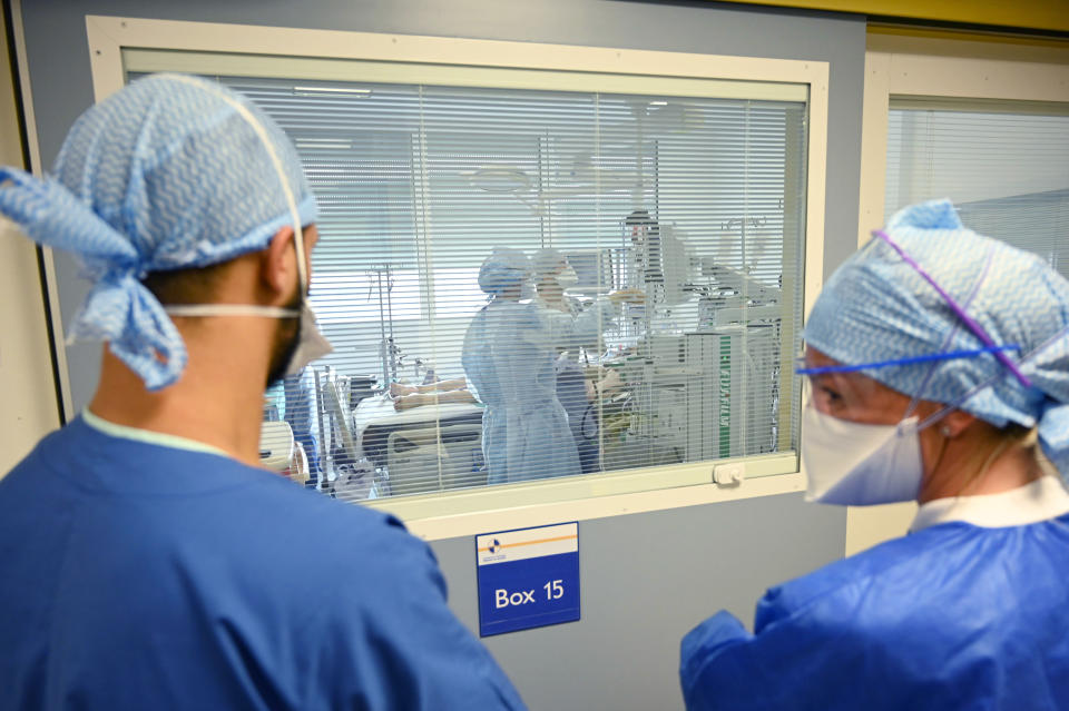 Medical workers stand in the ICU unit of La Timone public hospital, Friday Sept. 25, 2020 in Marseille, southern France. Angry restaurant and bar owners are demonstrating in Marseille to challenge a French government order to close all public venues as of Saturday to battle resurgent virus infections. The government argues that hospitals in this Mediterranean city are under strain and the closures are the only way to stem the spread while avoiding new lockdowns. (Christophe Simon, Pool via AP)