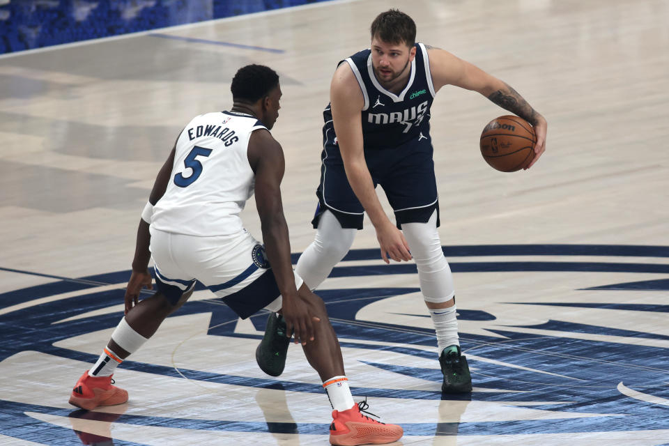 DALLAS, TEXAS - MAY 28: Luka Doncic #77 of the Dallas Mavericks is defended by Anthony Edwards #5 of the Minnesota Timberwolves during the first half in Game Four of the Western Conference Finals at American Airlines Center on May 28, 2024 in Dallas, Texas. NOTE TO USER: User expressly acknowledges and agrees that, by downloading and or using this photograph, User is consenting to the terms and conditions of the Getty Images License Agreement. (Photo by Tim Heitman/Getty Images)