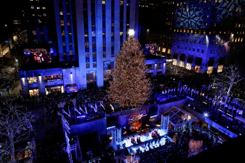 FILE PHOTO: People watch the Christmas tree lighting at Rockefeller Center in the Manhattan borough of New York