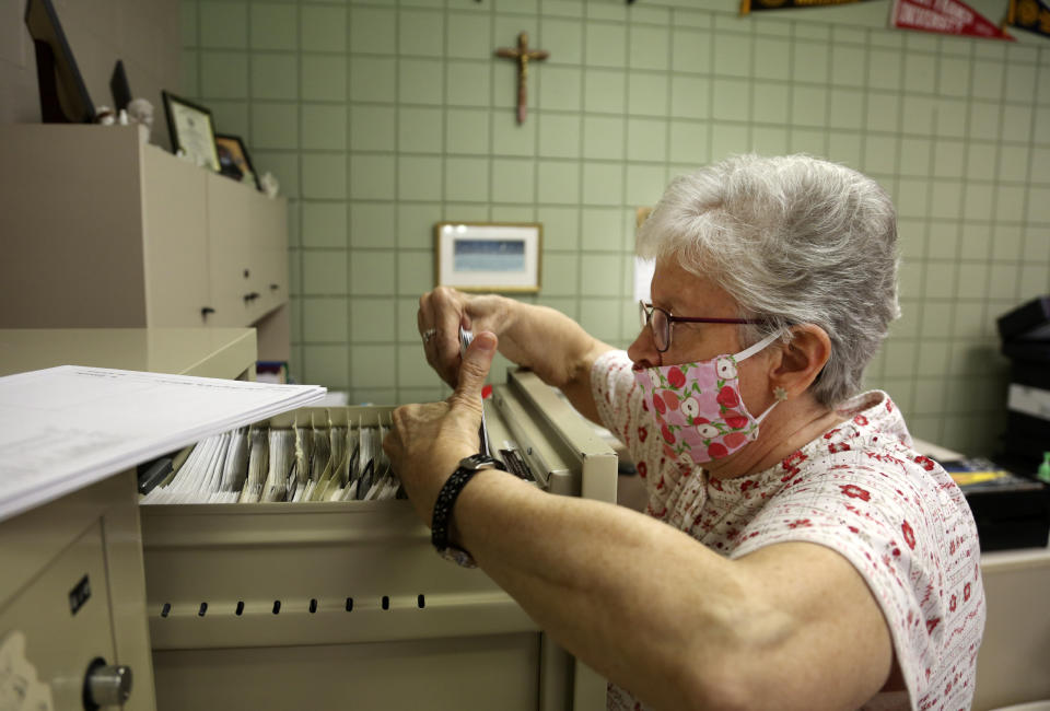 Sister Bridget Reilly, director of guidance, prepares student transcripts to send to other schools after the closure of Quigley Catholic High School in Baden, Pa., Monday, June 8, 2020. After 35 years with the school, Reilly learned of the closure along with other staffers May 29 via videoconference. (AP Photo/Jessie Wardarski)