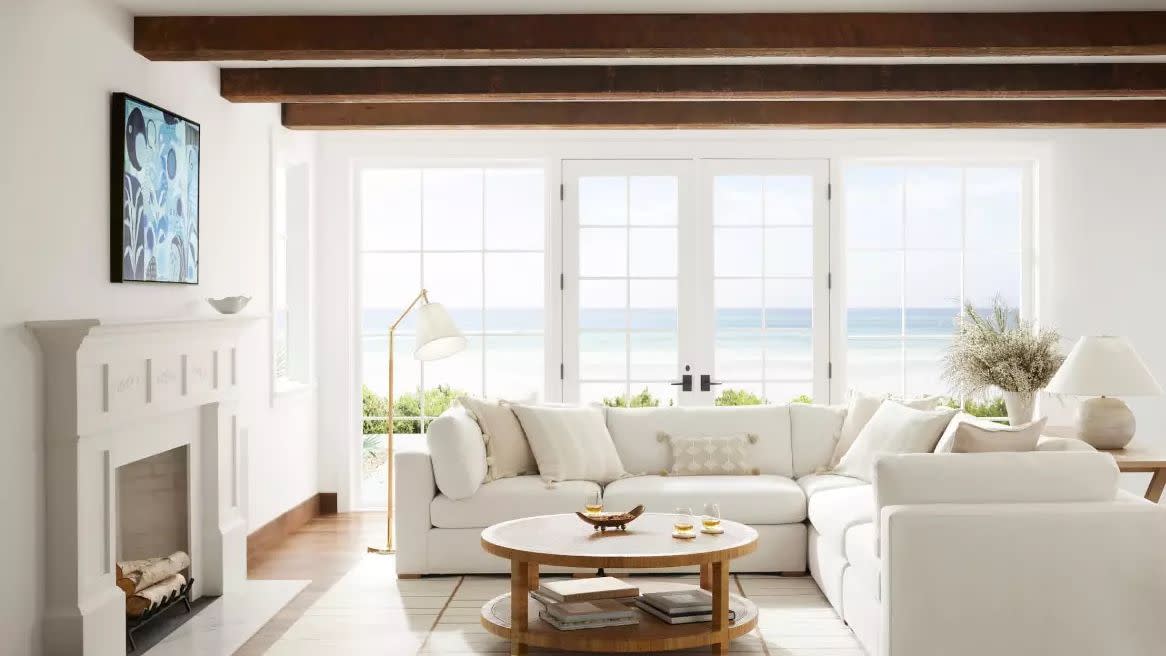 a living room with a white couch and a fireplace