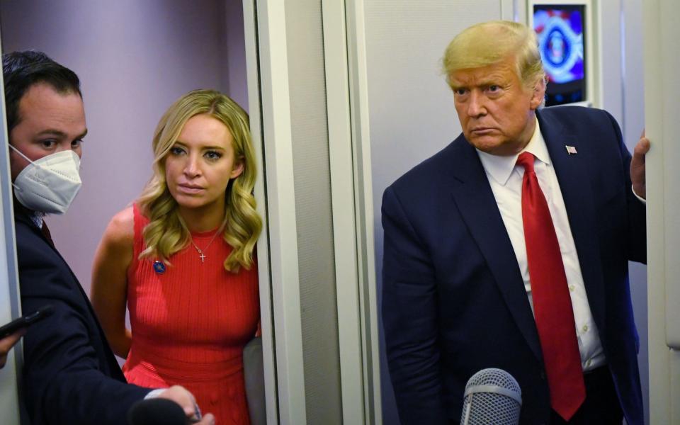 Mr Trump, alongside White House Press Secretary Kayleigh McEnany, speaking to reporters on Air Force One - MANDEL NGAN/AFP via Getty Images