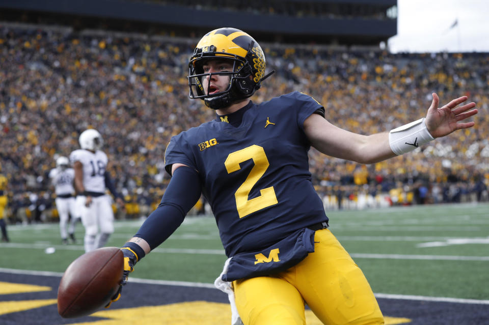 Michigan quarterback Shea Patterson celebrates his one-yard touchdown run in the first half of an NCAA college football game against the Penn State in Ann Arbor, Mich., Saturday, Nov. 3, 2018. (AP Photo/Paul Sancya)