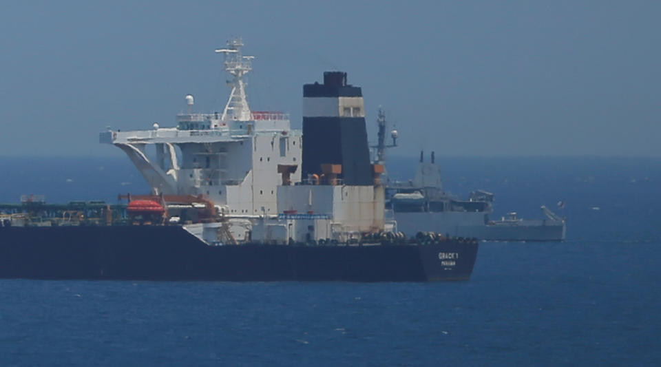 A British Royal Navy patrol vessel guards the oil supertanker Grace 1, that's on suspicion of carrying Iranian crude oil to Syria, as it sits anchored in waters of the British overseas territory of Gibraltar, historically claimed by Spain, July 4, 2019. REUTERS/Jon Nazca