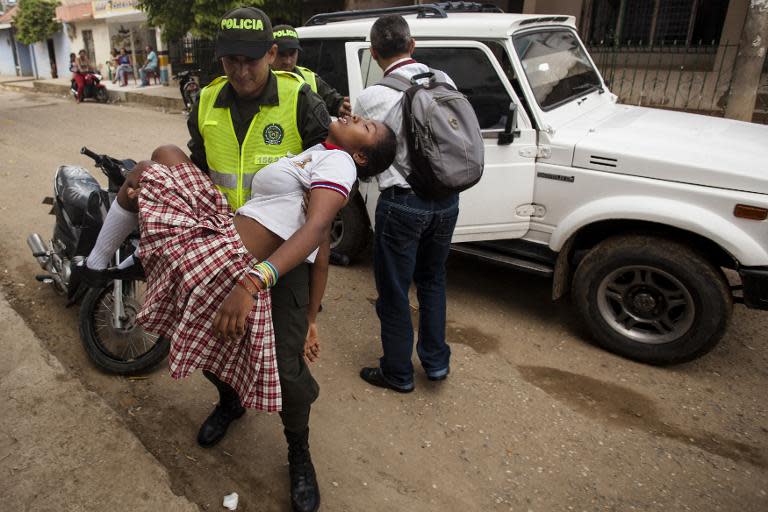 A teenage girl is brought to hospital in Carmen de Bolivar, Bolivar Province, Colombia, after fainting on September 2, 2014