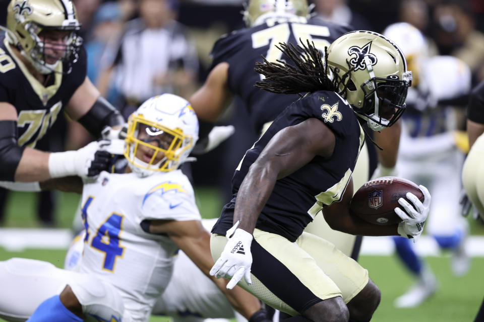 New Orleans Saints running back Alvin Kamara carries the ball up field during the first half of a preseason NFL football game against the Los Angeles Chargers in New Orleans, Friday, Aug. 26, 2022. (AP Photo/Butch Dill)