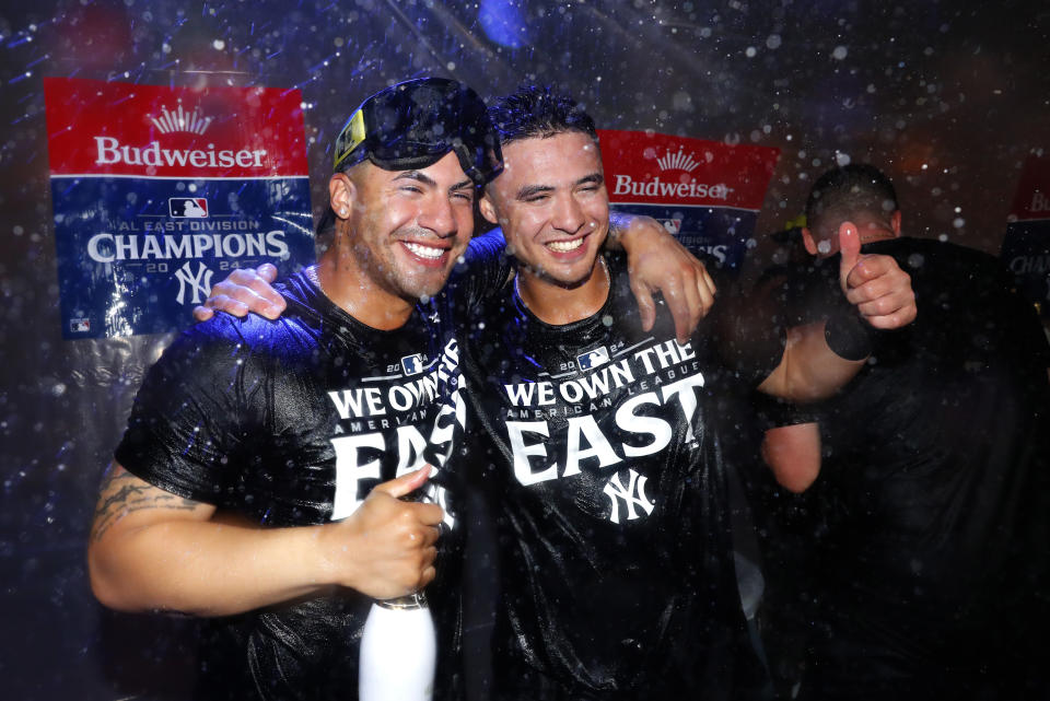 New York Yankees' Gleyber Torres, left, and Anthony Volpe, right, celebrate after clinching the American League East title in a baseball game against the Baltimore Orioles, Thursday, Sept. 26, 2024, in New York. (AP Photo/Noah K. Murray)