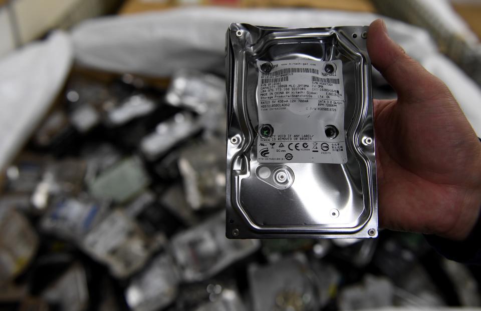 This photo taken on January 19, 2017 shows an employee displaying a physically destroyed hard disk drive at the Tokyo Eco Recycle company in Tokyo.
Electronic waste is rising sharply across Asia as higher incomes allow hundreds of millions of people to buy smartphones and other gadgets, with serious consequences for human health and the environment, according to a UN study released on January 15.
 / AFP PHOTO / TOSHIFUMI KITAMURA        (Photo credit should read TOSHIFUMI KITAMURA/AFP via Getty Images)