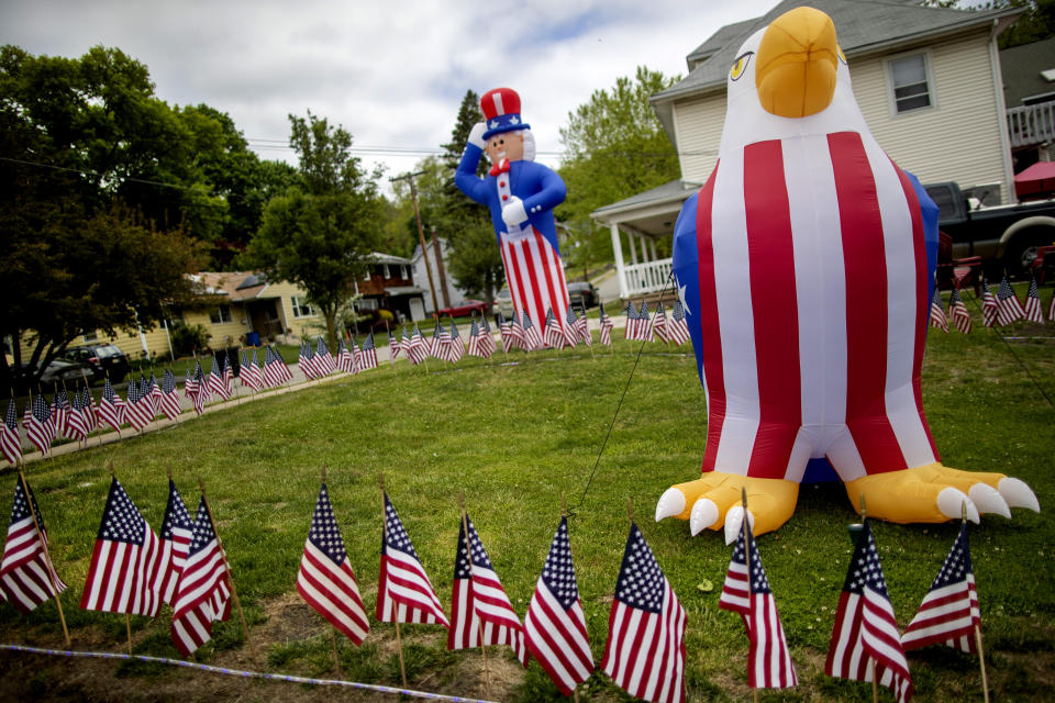 A home is adorned with patriotic decorations in honor of Memorial Day, Friday, May 22, 2020, in Boonton, N.J. (AP Photo/Mary Altaffer)