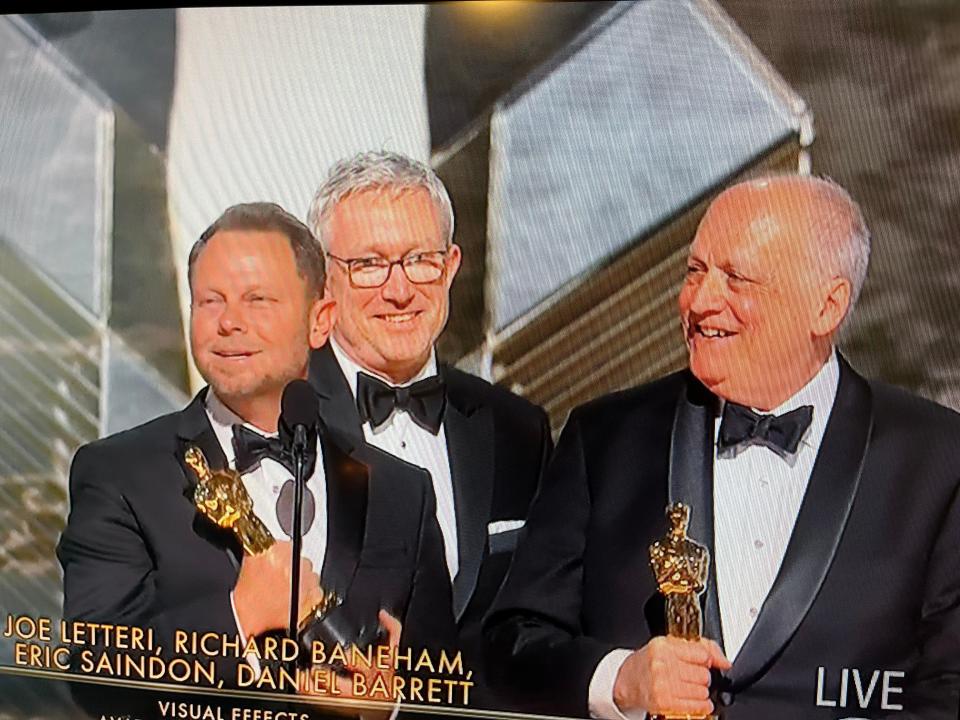 A smiling Joe Letteri, far right, holds his Academy Award won in this screen grab from Sunday's award telecast.