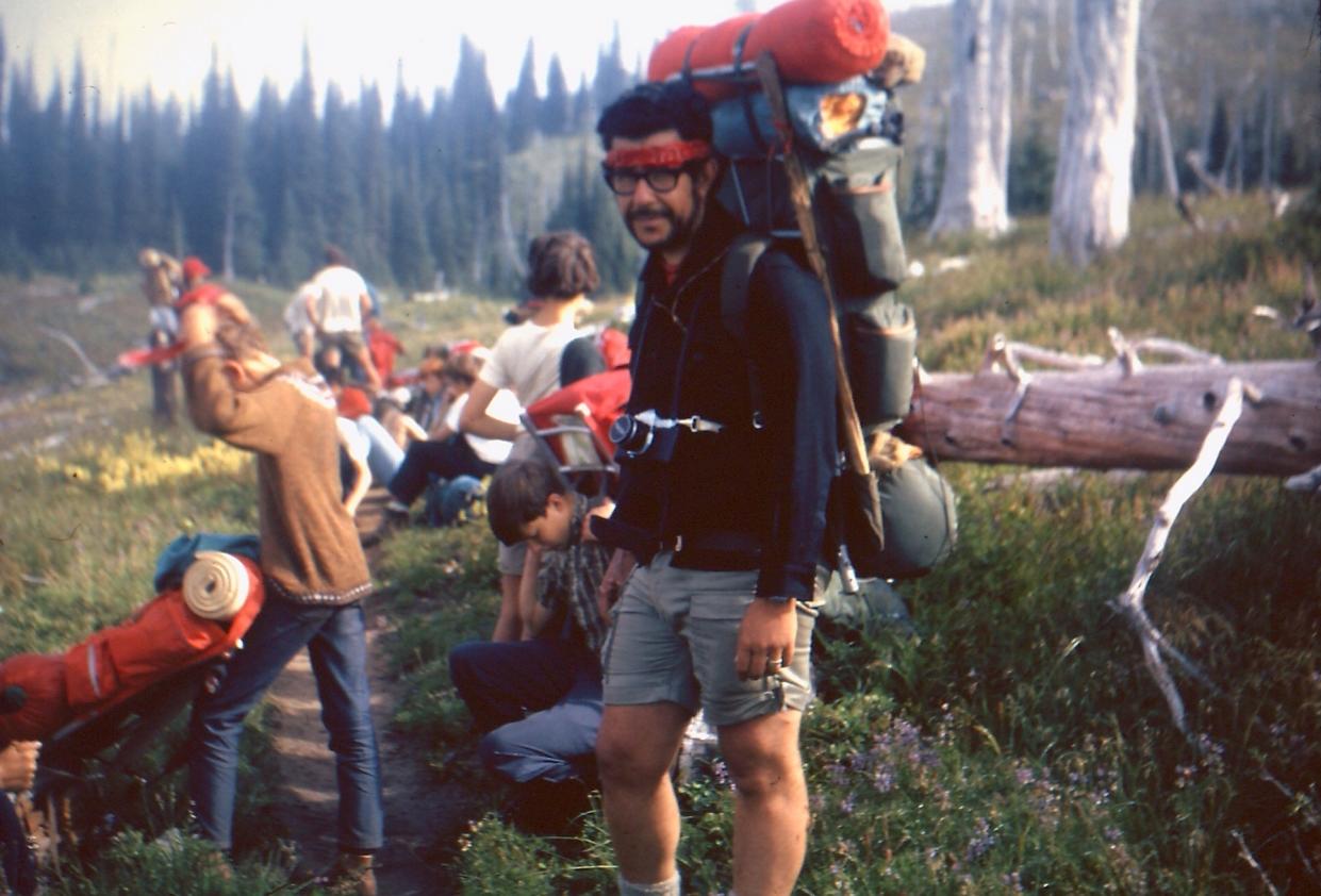Gordon’s father, Larry, leading a scout hiking trip, with a young Gordon lounging behind him
