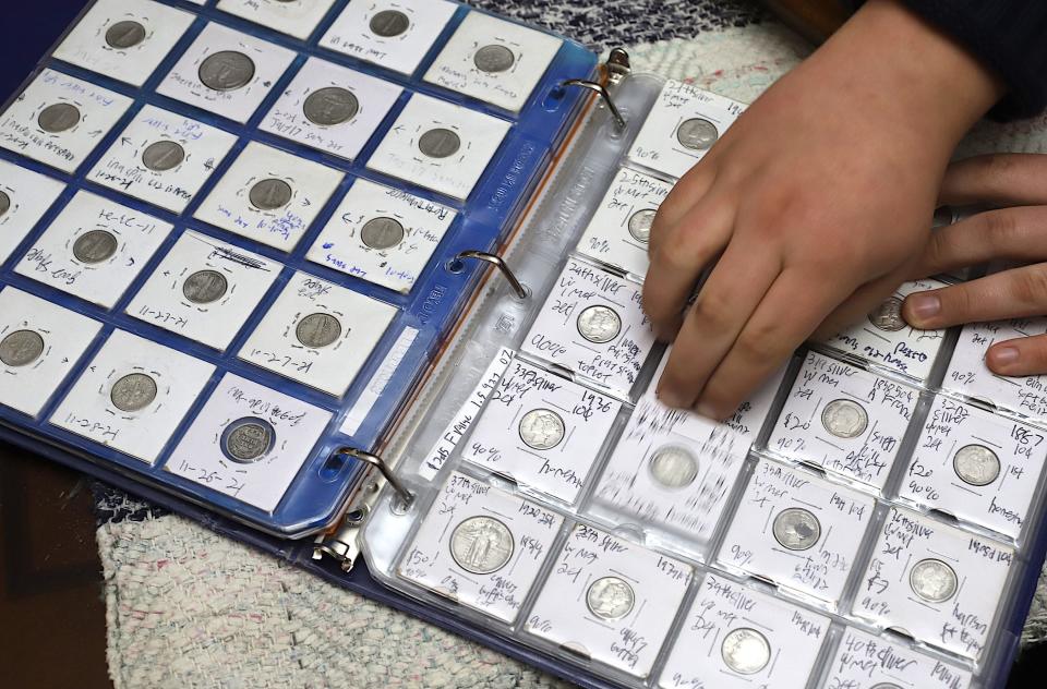 Caleb Colter labels the coins he find and keeps them in a folder Thursday, Dec. 1, 2022, at his home in West Burlington.