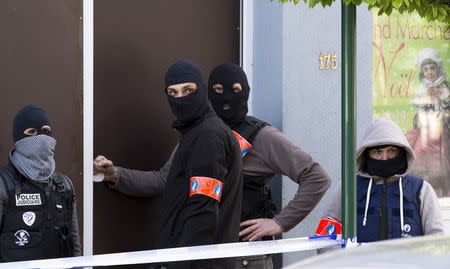 Belgium special forces police secure access during a police operation to search an apartment complex in the Brussels district of Uccle, Belgium, April 12, 2016. REUTERS/Yves Herman