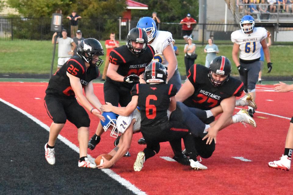 Mitchell's Nick Mundy stretches the ball across the goal-line to complete a second-quarter two-point conversion in last year's 28-26 win at  Edgewood.