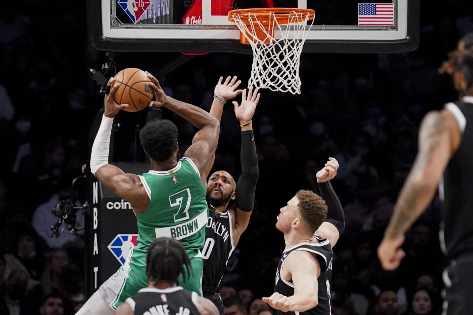Boston Celtics guard Jaylen Brown (7) shoots against Brooklyn Nets guard Jevon Carter (0) during the first half of an NBA basketball game, Tuesday, Feb. 8, 2022, in New York. (AP Photo/John Minchillo)