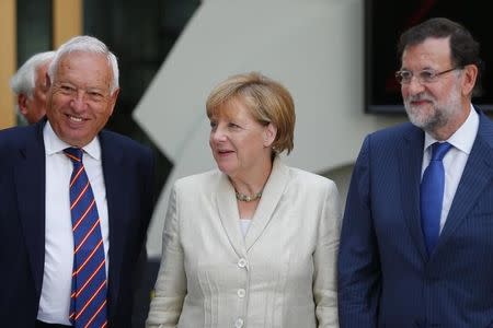 German Chancellor Angela Merkel, Spanish Prime Minister Mariano Rajoy (R) and spanish Foreign Minister Jose Manuel Garcia-Margallo arrive for a German-Spanish business meeting in Berlin, Germany, September 1, 2015. REUTERS/Hannibal Hanschke