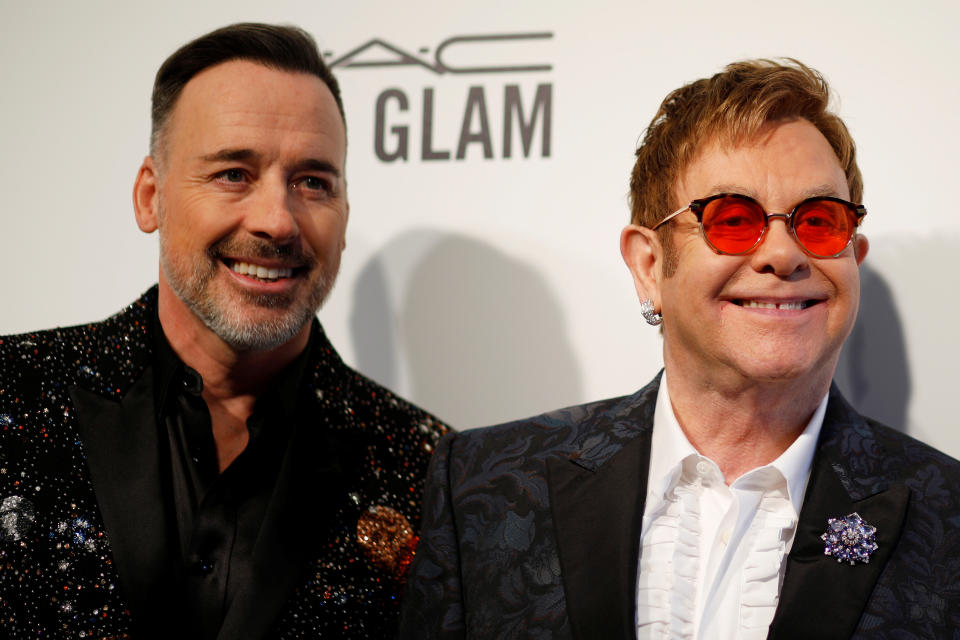 Elton John and his husband David Furnish (L) arrive at the 2017 Elton John AIDS Foundation Academy Awards Viewing Party in Los Angeles, California, U.S., February 26, 2017.   REUTERS/Brian Snyder