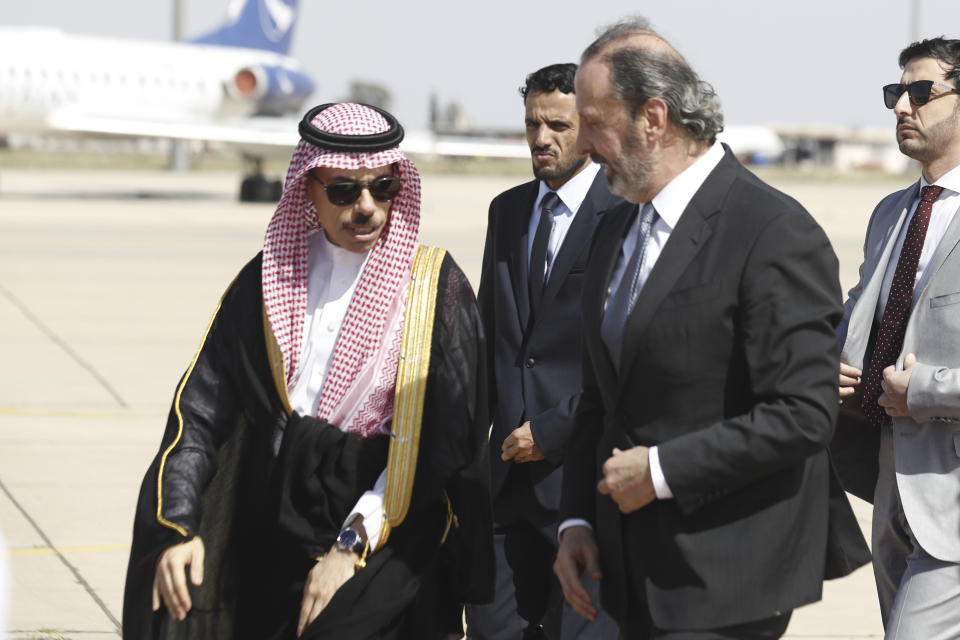 Saudi Minster of Foreign Affairs Faisal bin Farhan is escorted by the Syrian Minister of Presidential Affairs Mansour Azzam upon his arrival at Damascus airport Tuesday, April 18, 2023. (AP Photo/Omar Sanadiki)