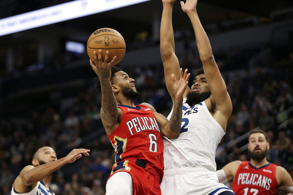 New Orleans Pelicans guard Nickeil Alexander-Walker (6) shoots against Minnesota Timberwolves center Karl-Anthony Towns (32) with Timberwolves guard Jordan McLaughlin, left, and Pelicans center Jonas Valanciunas (17) looking on in the first half of an NBA basketball game, Monday, Oct. 25, 2021, in Minneapolis. (AP Photo/Andy Clayton-King)