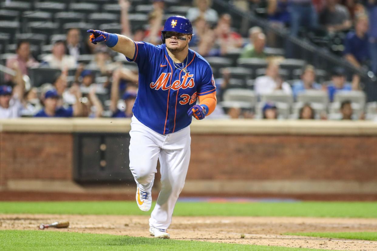 New York Mets designated hitter Daniel Vogelbach (32) points to the dugout after hitting a game-tying RBI single in the eighth inning against the Washington Nationals on July 27, 2023, at Citi Field.