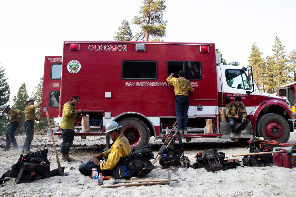 The San Bernardino Old Cajon  professional hand crew takes a break to hydrate during the response to a fire emergency at Janesville Grade, CA, Aug. 18, 2021.  Benjamin Chambers/The Republic