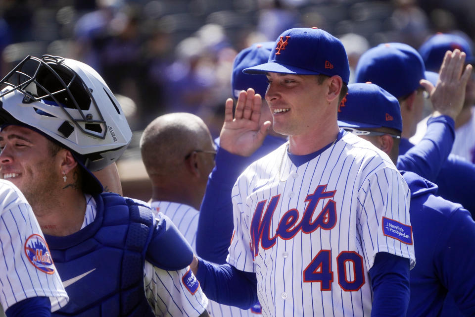 New York Mets relief pitcher Drew Smith, right, smiles as teammates celebrate after a baseball game against Philadelphia Phillies, Thursday, June 1, 2023, in New York. (AP Photo/Bebeto Matthews)