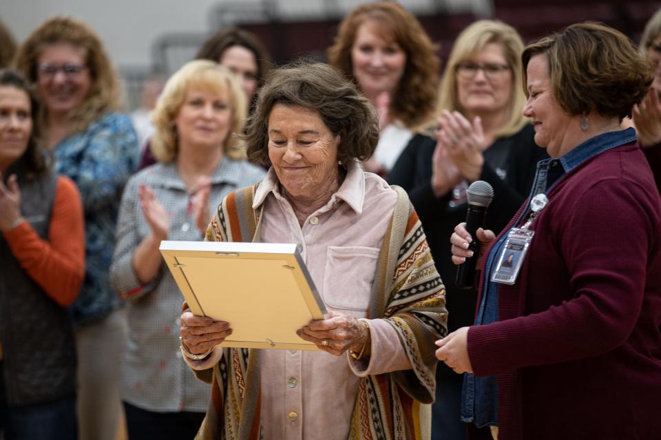 Superintendent Emily Lorenz hands a plaque to former Calallen girls basketball coach Leta Andrews during a gym dedication ceremony in her honor at Calallen High School on Friday, Jan. 13, 2023, in Corpus Christi, Texas. 