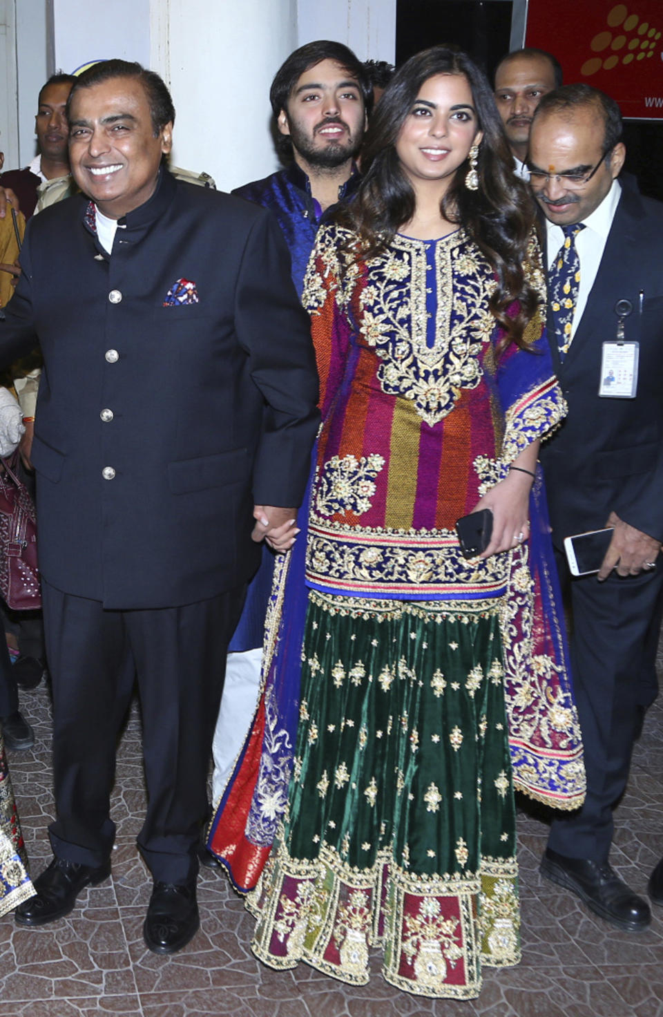 FILE - In this Friday, Nov. 30, 2018 file photo, Chairman of Reliance Industries Mukesh Ambani, left, and his daughter Isha Ambani, arrive to attend the wedding of Bollywood actress Priyanka Chopra and Nick Jonas in Jodhpur, India. Isha, the daughter of India’s richest mogul, is to wed Anand Piramal, the son of one of India’s biggest industrialists, at the Ambani estate in Mumbai on Wednesday, Dec. 12, capping off an extravagant days-long event. (AP Photo/Sunil Verma, File)