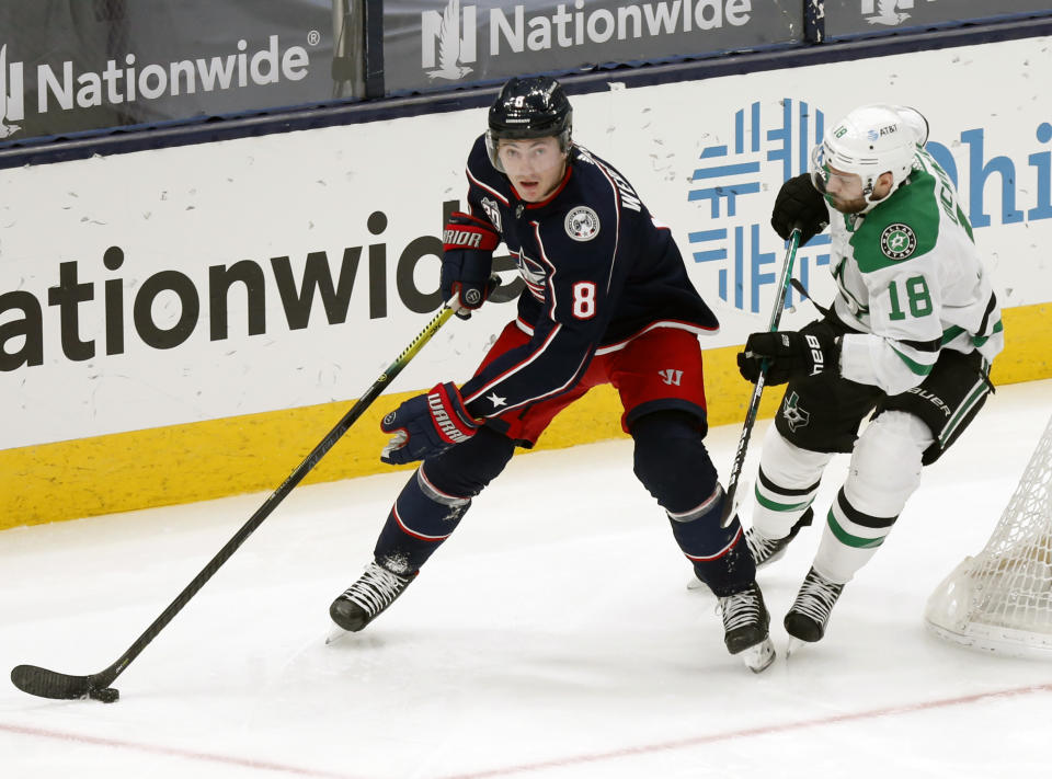 FILE - In this March 14, 2021, file photo, Columbus Blue Jackets defenseman Zach Werenski, left, controls the puck in front of Dallas Stars forward Jason Dickinson during the third period of an NHL hockey game in Columbus, Ohio. It is clear from recent signings who will form the core of the retooled Blue Jackets. Forwards Oliver Bjorkstrand and Boone Jenner are inked through the 2025-26 season, Werenski is locked up through 2026-27, and last week goaltender Elvis Merzlikins signed an extension through ‘26-’27. (AP Photo/Paul Vernon, File)