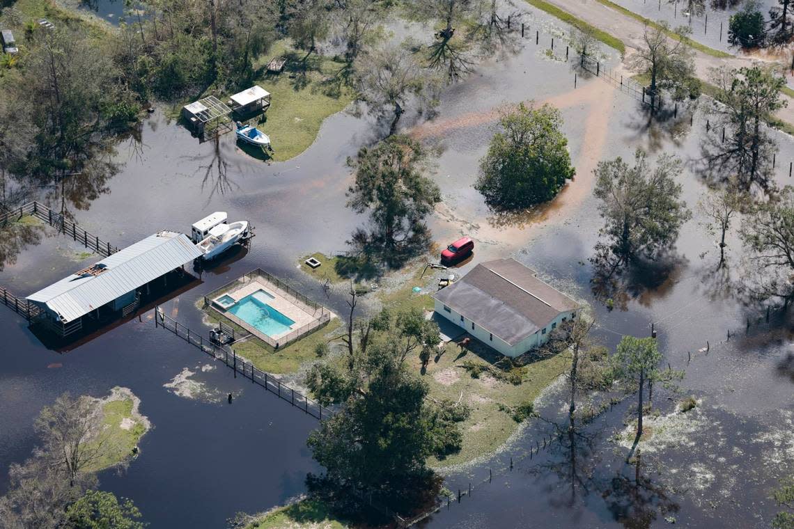 An aerial view of a home surrounded by a flooded field caused by Hurricane Ian in the vicinity of Fort Myers on Thursday, Sept. 29, 2022.