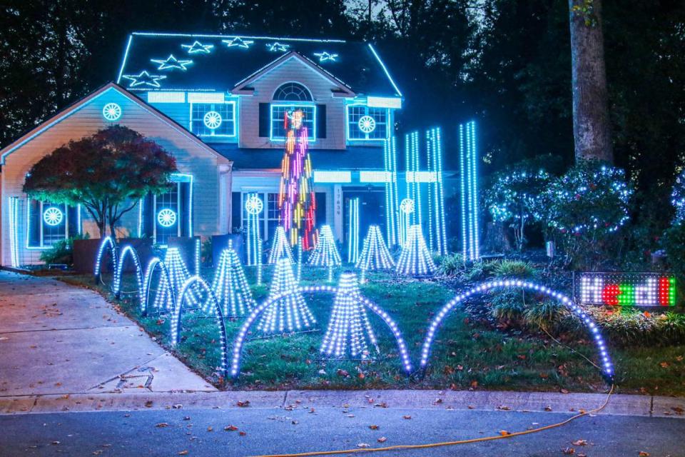 Bob Hlastala’s light show house in Huntersville includes Christmas music broadcasting on an FM station.