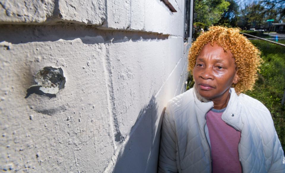 Josie Knott shows a bullet hole on the side of her home in Montgomery, Alabama, on March 13, 2023.