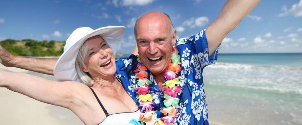 Happy senior couple at tropical beach