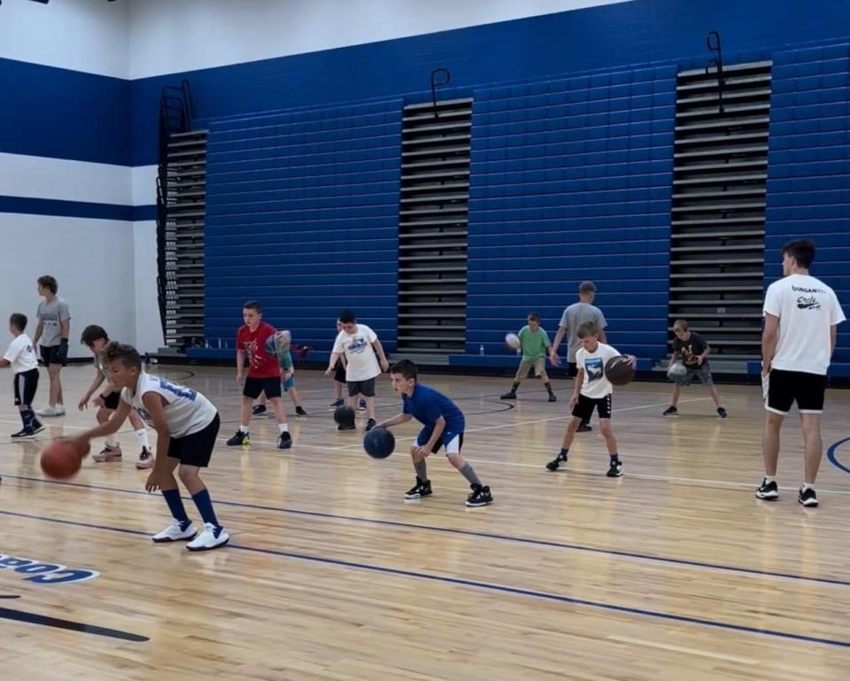 A group of young players work on their dribbling during a recent session of the Cambridge Boys Basketball Camps held at Cambridge High School.