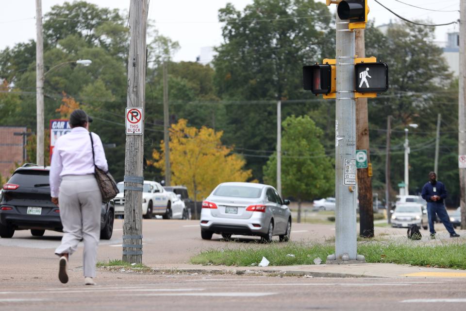 A woman walks across South Bellevue Boulevard at the intersection of Lamar Avenue where in 2017, there were two fatal pedestrian accidents. 