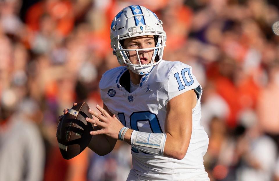 FILE - North Carolina quarterback Drake Maye (10) plays during the first half of an NCAA college football game Saturday, Nov. 18, 2023, in Clemson, S.C. Maye is a possible first round pick in the NFL Draft. (AP Photo/Jacob Kupferman, File)