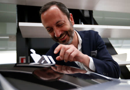 Infiniti, Nissan Motor's premium brand, Executive Design Director Karim Habib smiles behind the brand's car model at its Global Design Center in Atsugi, Japan, April 18, 2018. Picture taken April 18, 2018. REUTERS/Toru Hanai